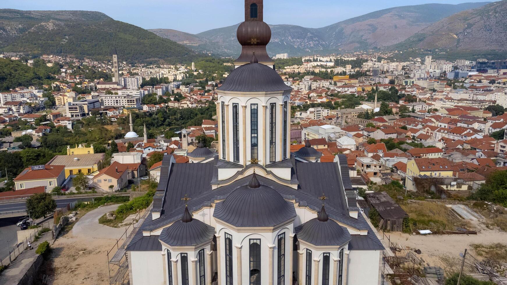 Orthodox church of the holy trinity with bell tower centered in the photo. Colorful city background of Mostar, Bosnia and Herzegovina. Travel aerial view tourist attraction photo