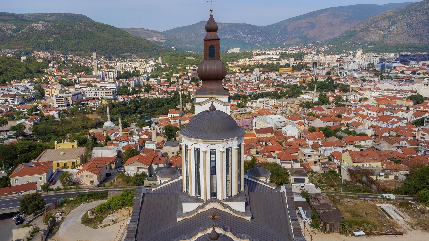Orthodox church of the holy trinity with bell tower centered in the photo. Colorful city background of Mostar, Bosnia and Herzegovina. Aerial view tourist attraction photo