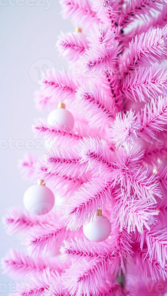 close-up of a pink artificial christmas tree with white ornaments photo