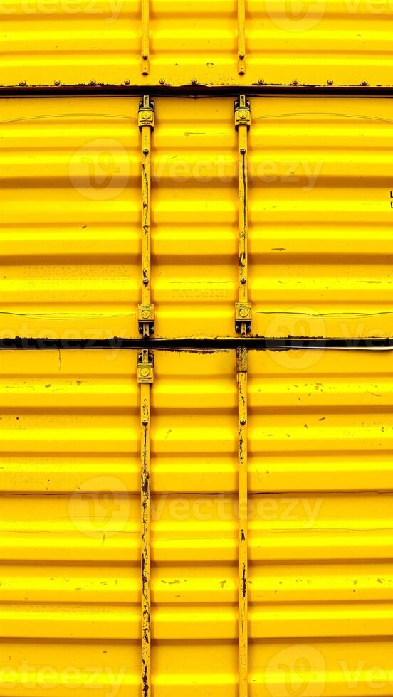 close-up view of vibrant yellow corrugated metal texture photo