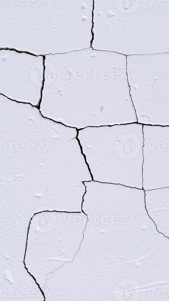 close-up view of a white textured surface with a network of cracks photo