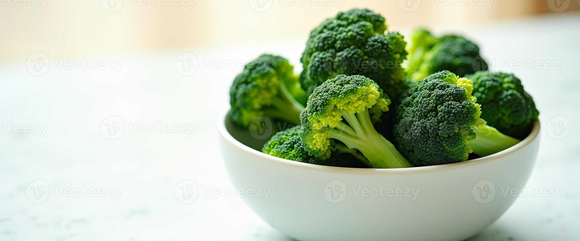 close-up of fresh broccoli florets in a white bowl photo