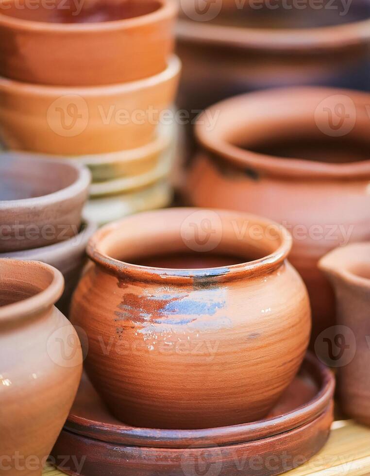 Clay pots in earthy tones. Handmade pottery. photo