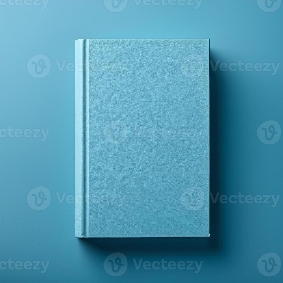 Blue book with blank hard cover on matching backdrop. Minimalist template design. Flat lay. Mock-up photo