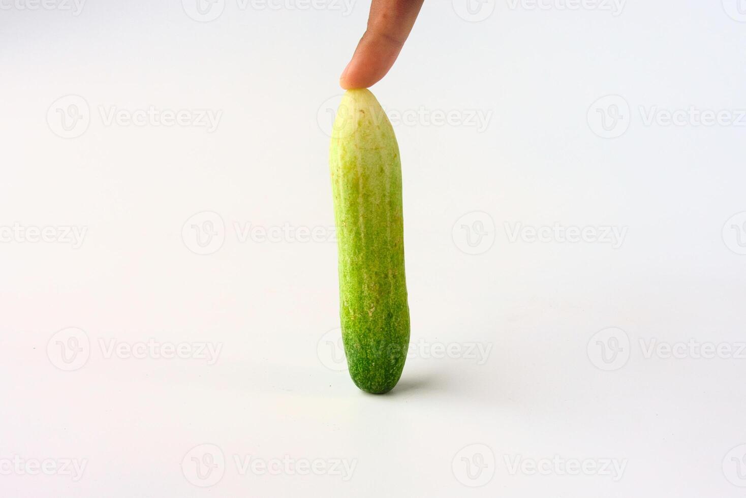 Fresh Green Cucumber Upright With Finger Touch on White Background photo