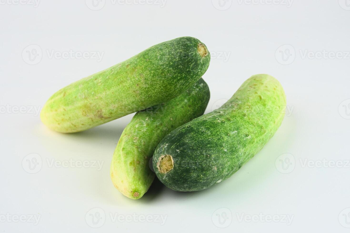Fresh Green Cucumbers Arranged on a Clean White Background for Culinary Use photo
