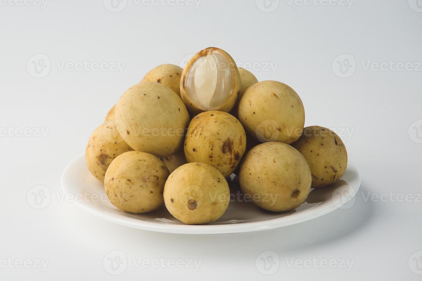 Fresh Langsat Fruits Arranged on a White Plate Highlighting Their Juicy Interior photo