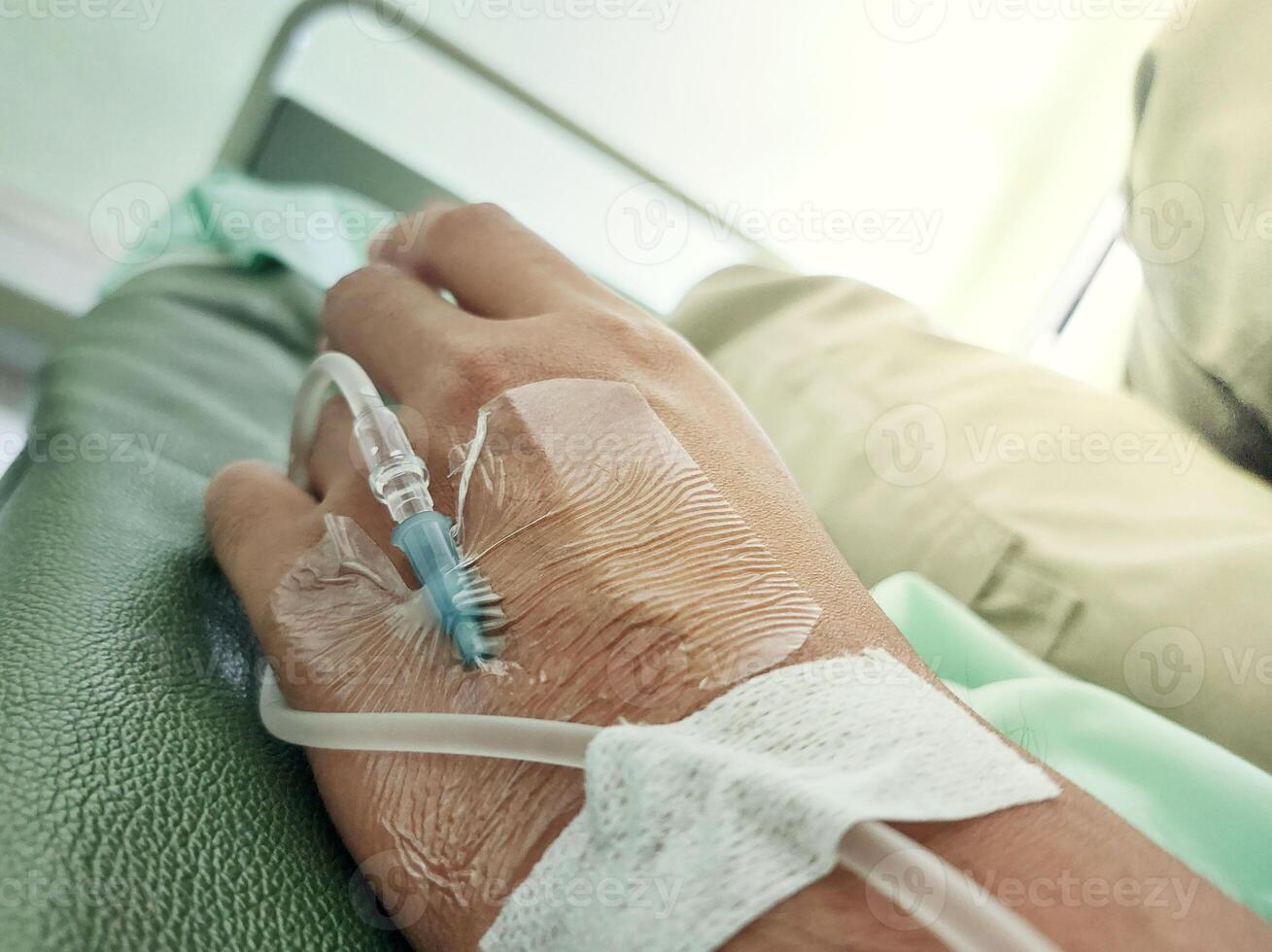 Close-Up of Patient's Hand Receiving Intravenous Drip in Hospital photo