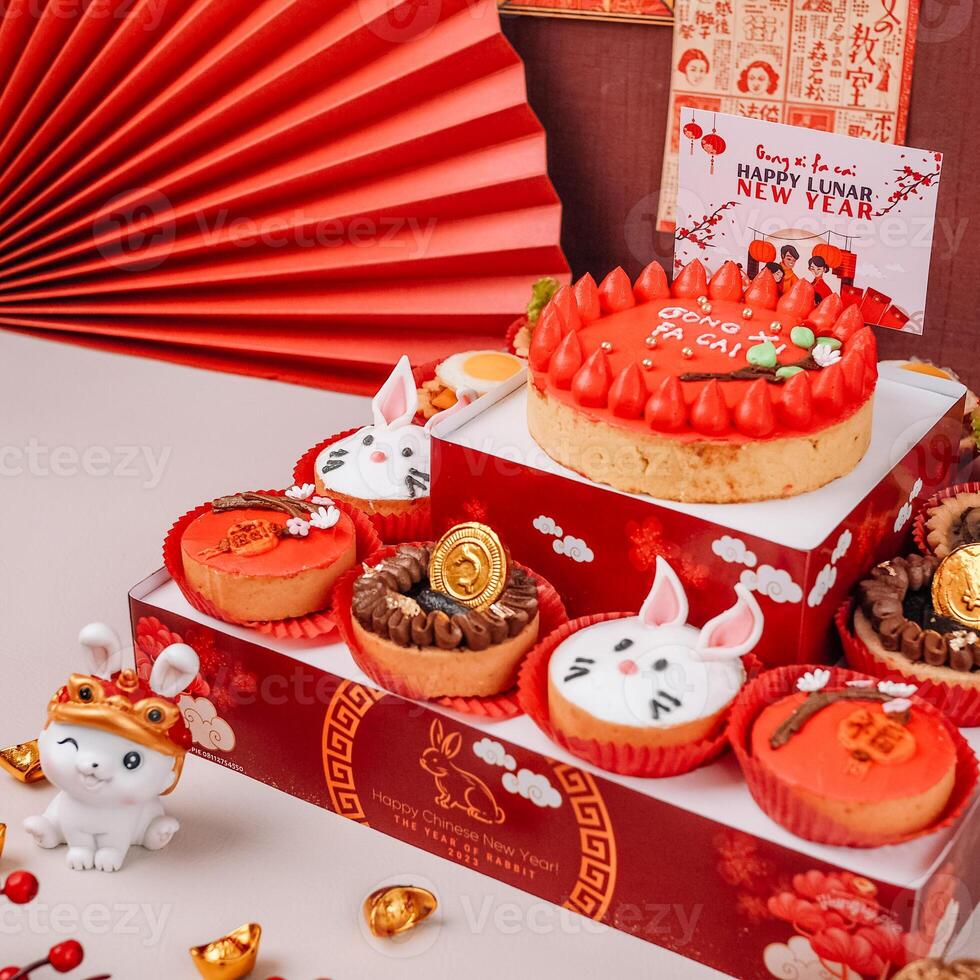 Close up photography of chinese new year tower pie with rabbit character and Chinese poster background photo