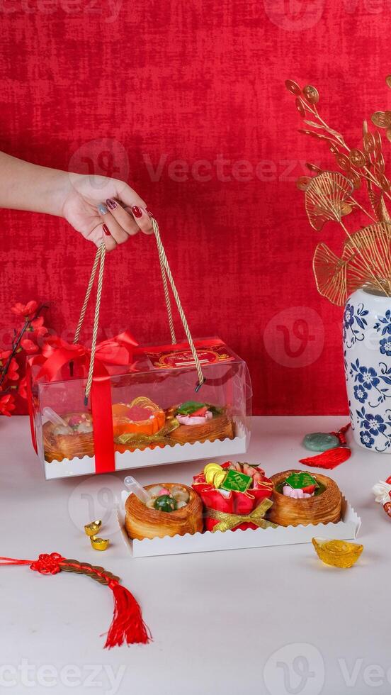 Ladies Hand Holding Chinese New Years Hampers with Chinese Ornaments Background photo