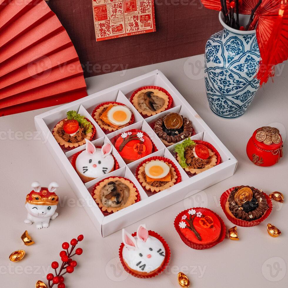 A box of Mini Chinese New Years Cake with Chinese Ornaments Background photo