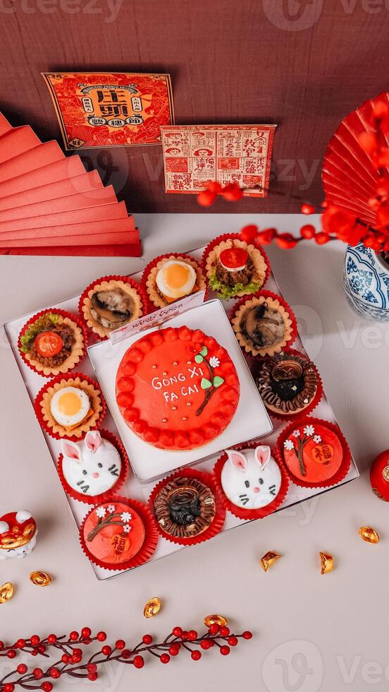 Top View of Chinese New Year Food with Chinese Poster Background and Ornaments. photo