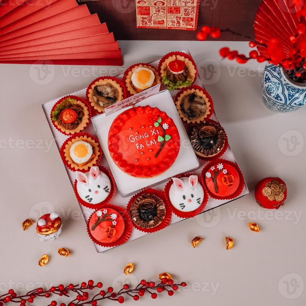 Top View of Chinese New Years Cake Variety with Chinese Ornaments Background photo