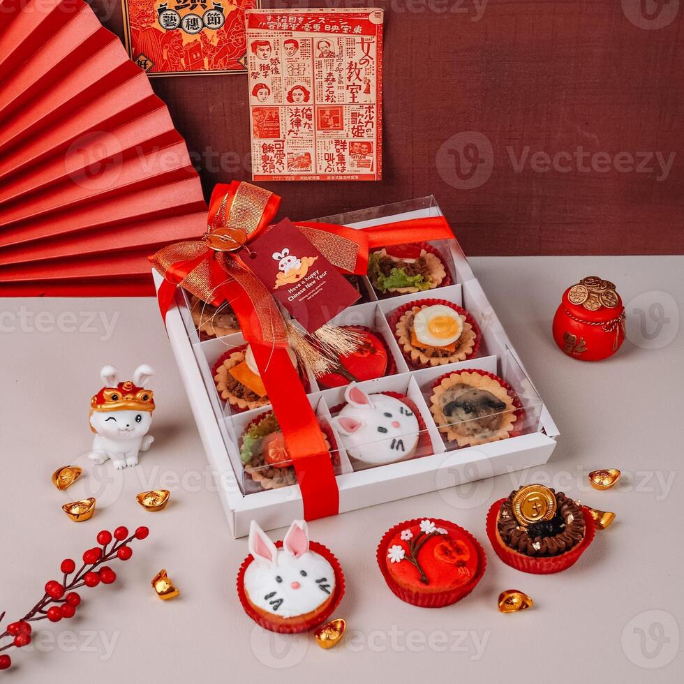 Variety of Chinese New Years Cakes in a Box with Chinese Ornaments Background photo