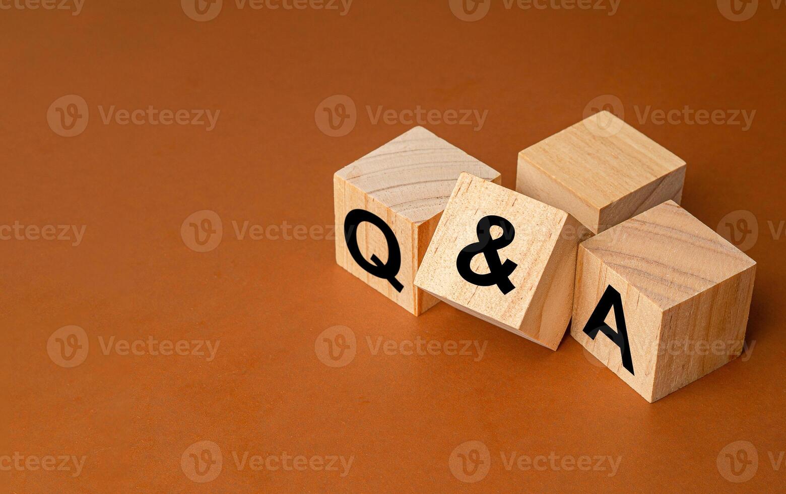 Wooden cubes with words Q and A on a brown background photo