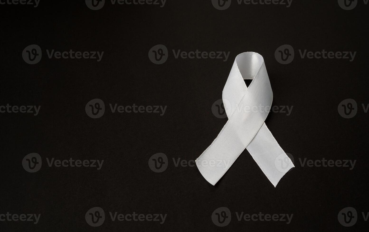 Top view of a white ribbon on a black background. Space for text photo