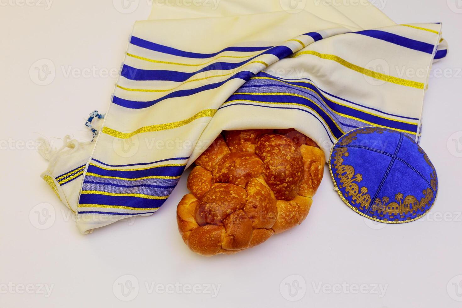 A table set for Shabbat with lighted candles, challah bread and wine. photo