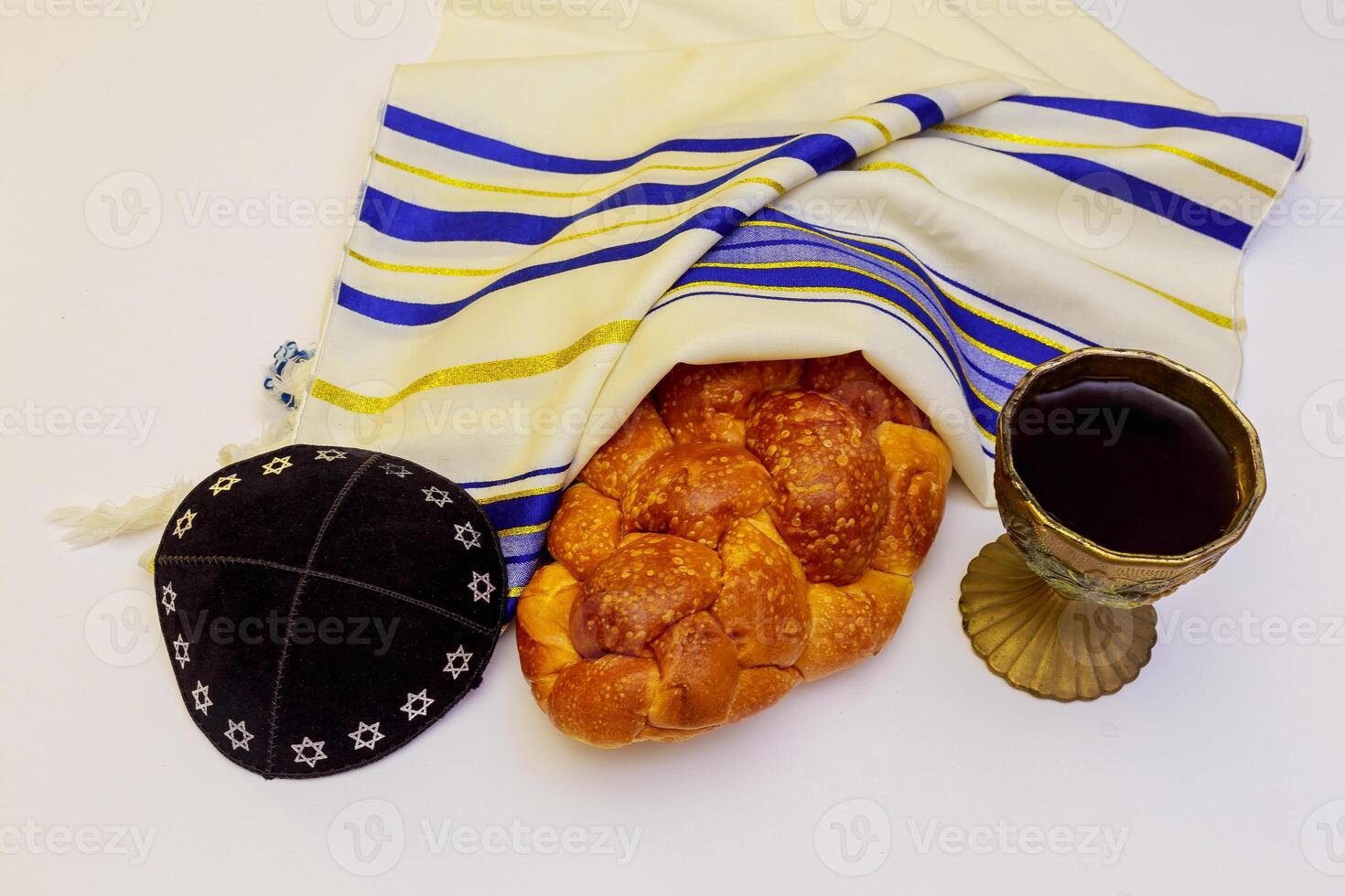 Jewish holiday Sabbath Prayer Shawl Tallit table set for Shabbat with lighted candles, challah bread and wine. photo