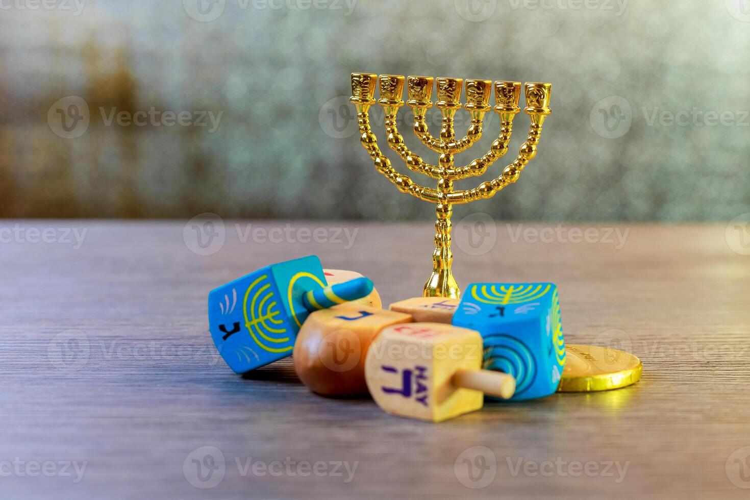 Image of jewish holiday Hanukkah with wooden dreidels colection spinning top and chocolate coins on the table photo