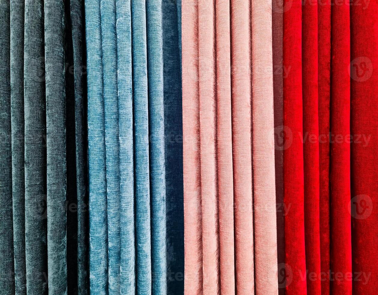 Colorful fabric samples hanging in a store, showcasing a variety of textures and colors photo