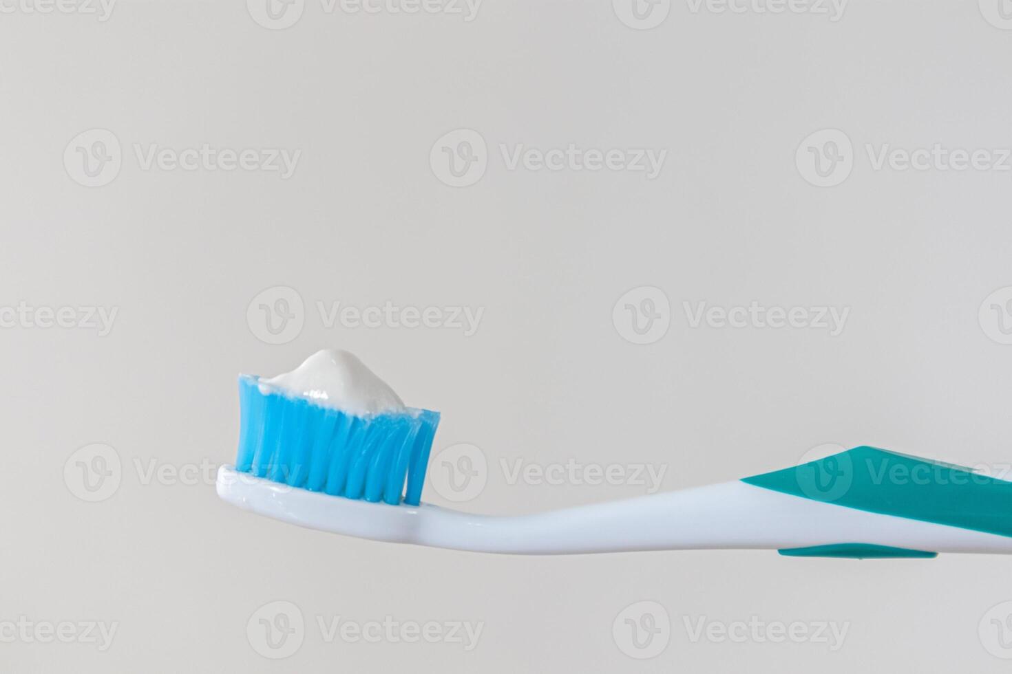 A toothbrush smeared with toothpaste photo