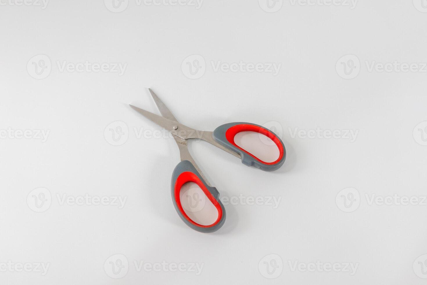An open pair of scissors on a white background photo