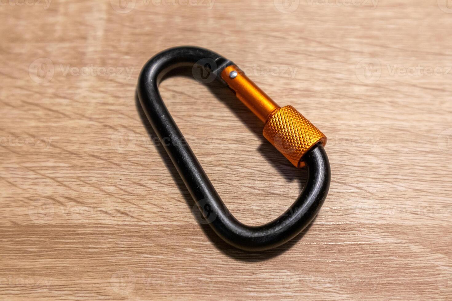 A carabiner for hanging keys or items not for climbing on a wooden table photo