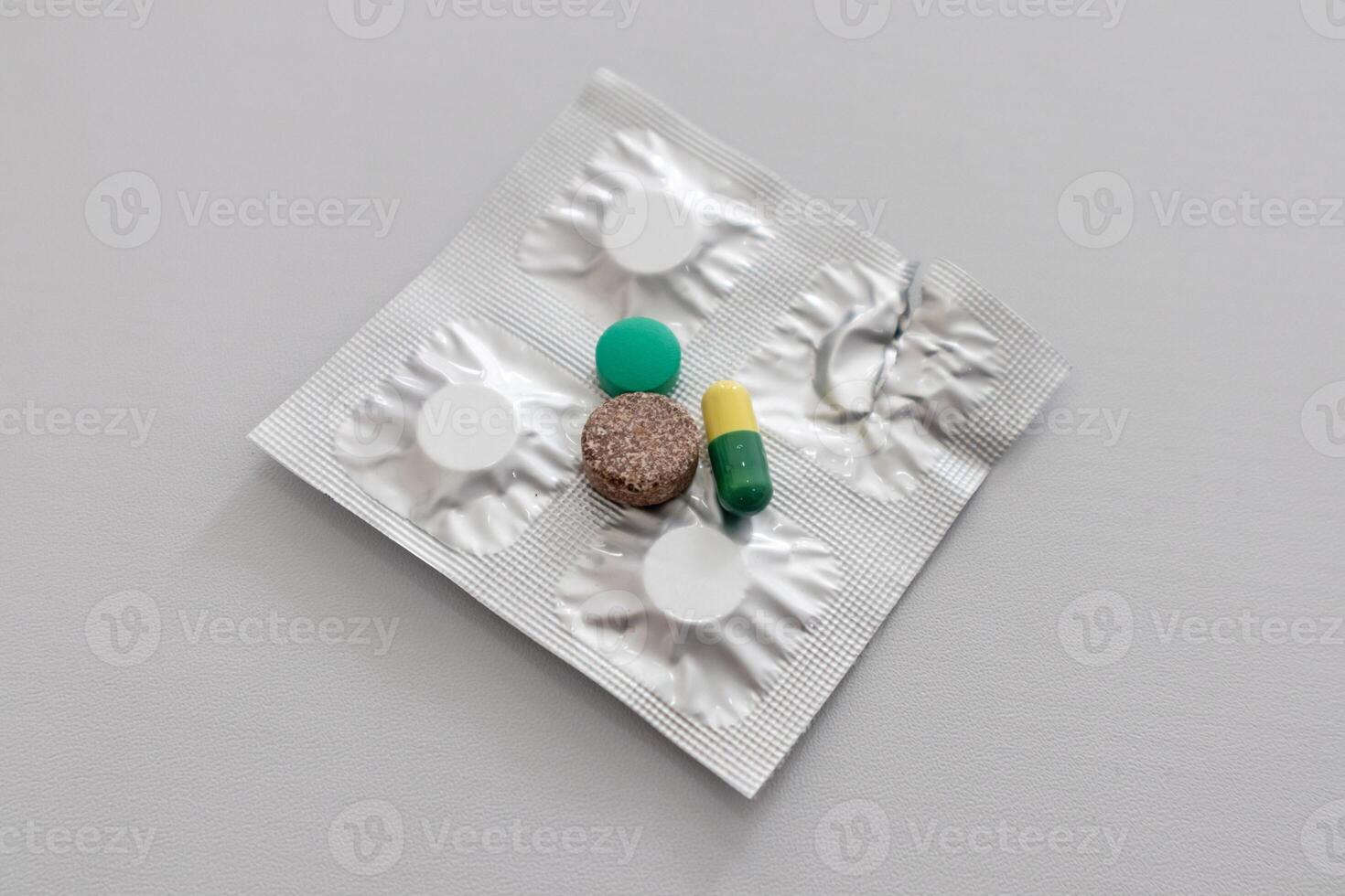 Three types of medical drugs and pills on the silver shiny package photo