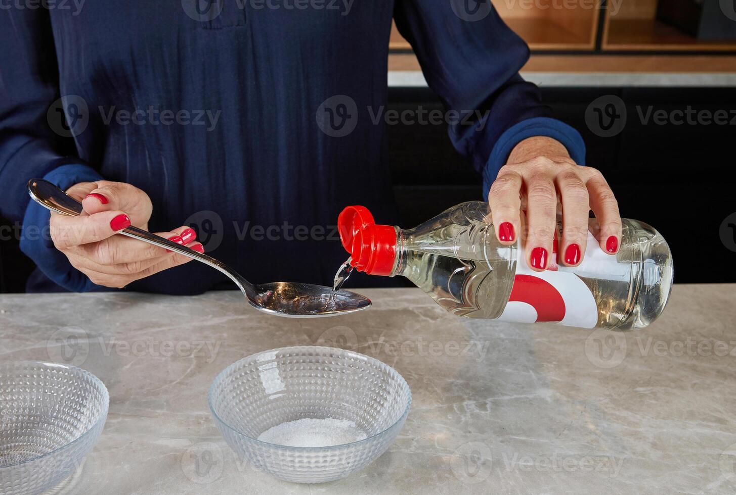Hands stirring seasoned sushi rice in a bamboo bowl using a wooden spatula, an essential step in sushi preparation. photo