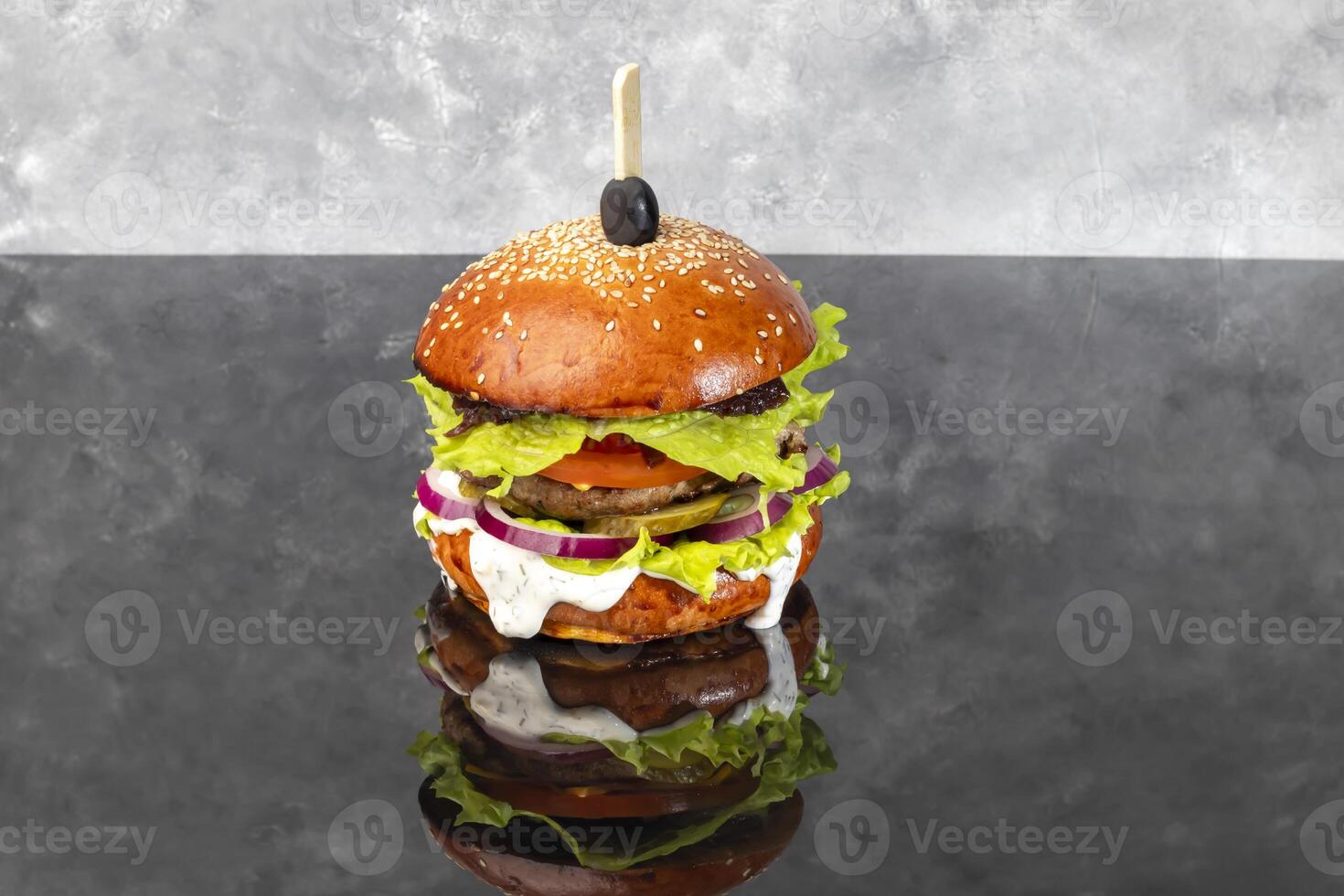 Grilled veggie burger with three cheese patty tomato cheese cucumber and lettuce photo