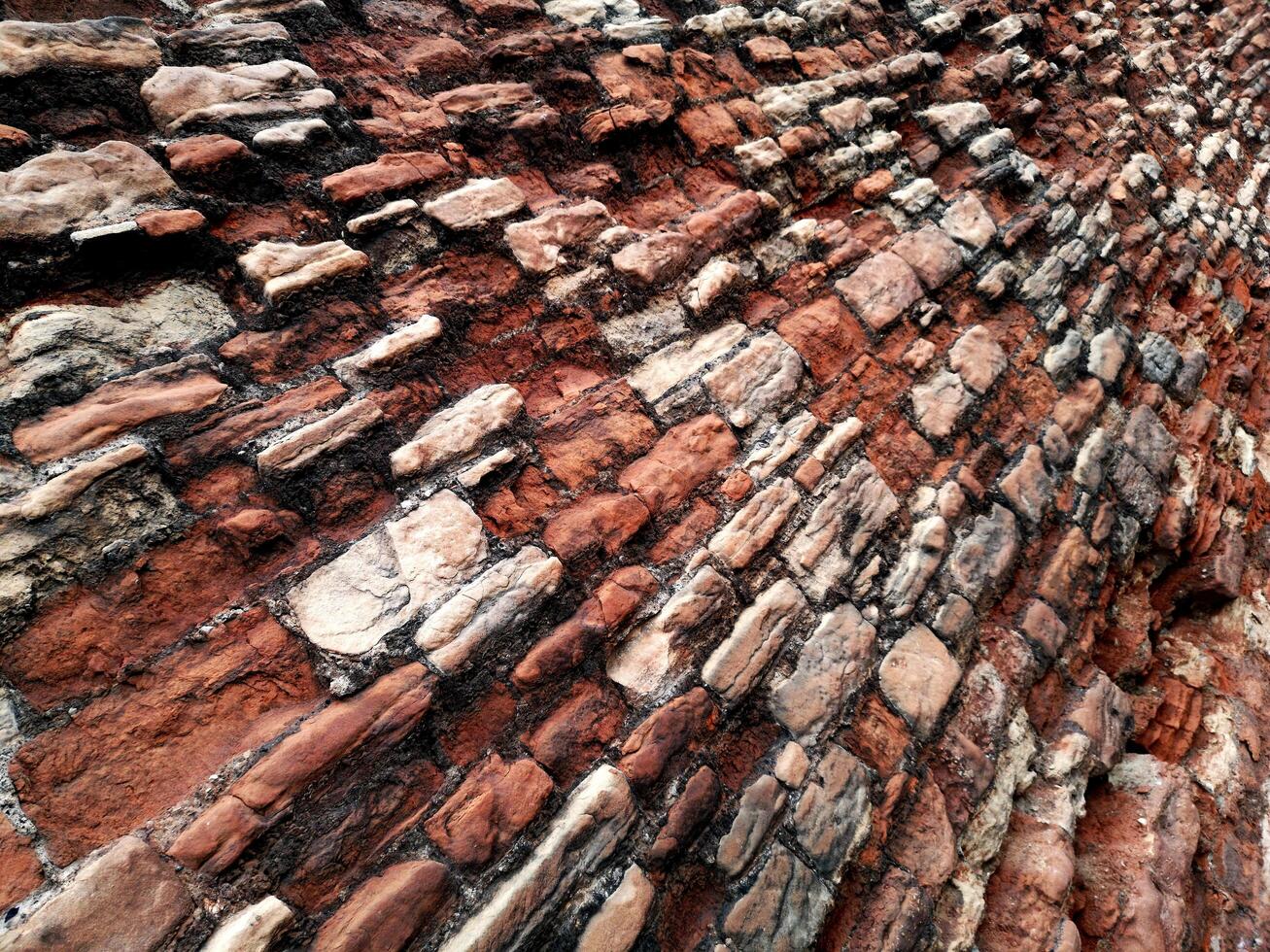 ERODED RED BRICK WALL photo