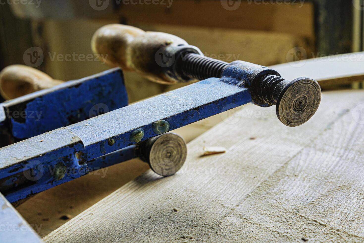 Carpenter's clamps in the carpentry workshop photo