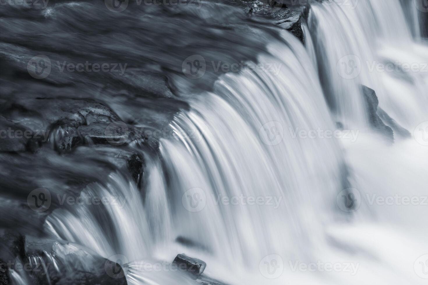 A black and white photo of a waterfall