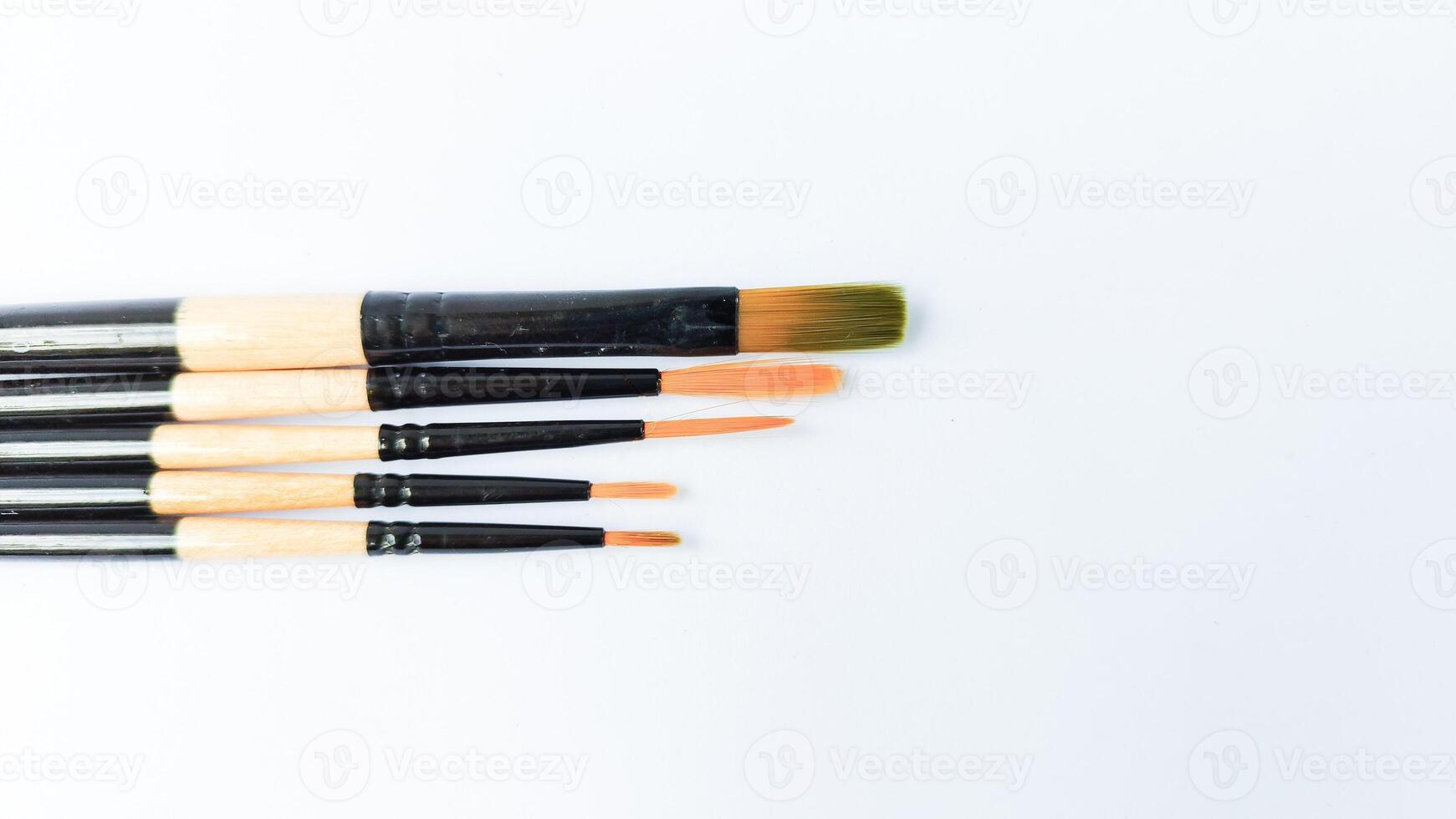 Different brushes with paints on white background photo