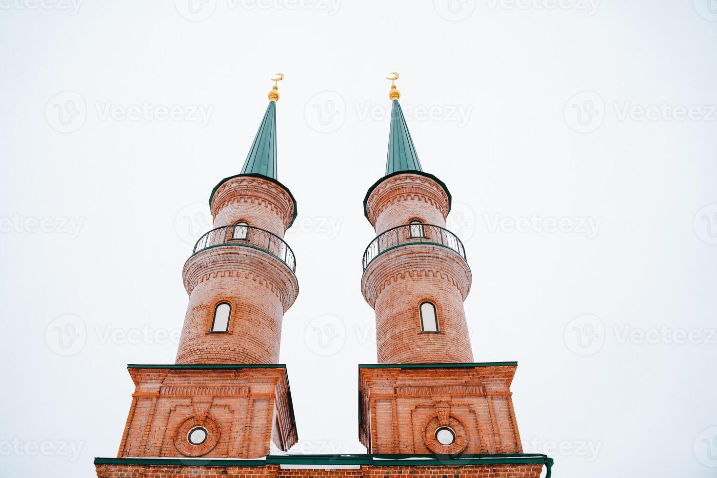 A sturdy brick building features two impressive towers that rise majestically atop its structure, enhancing its architectural beauty and serving as a notable landmark in the area photo