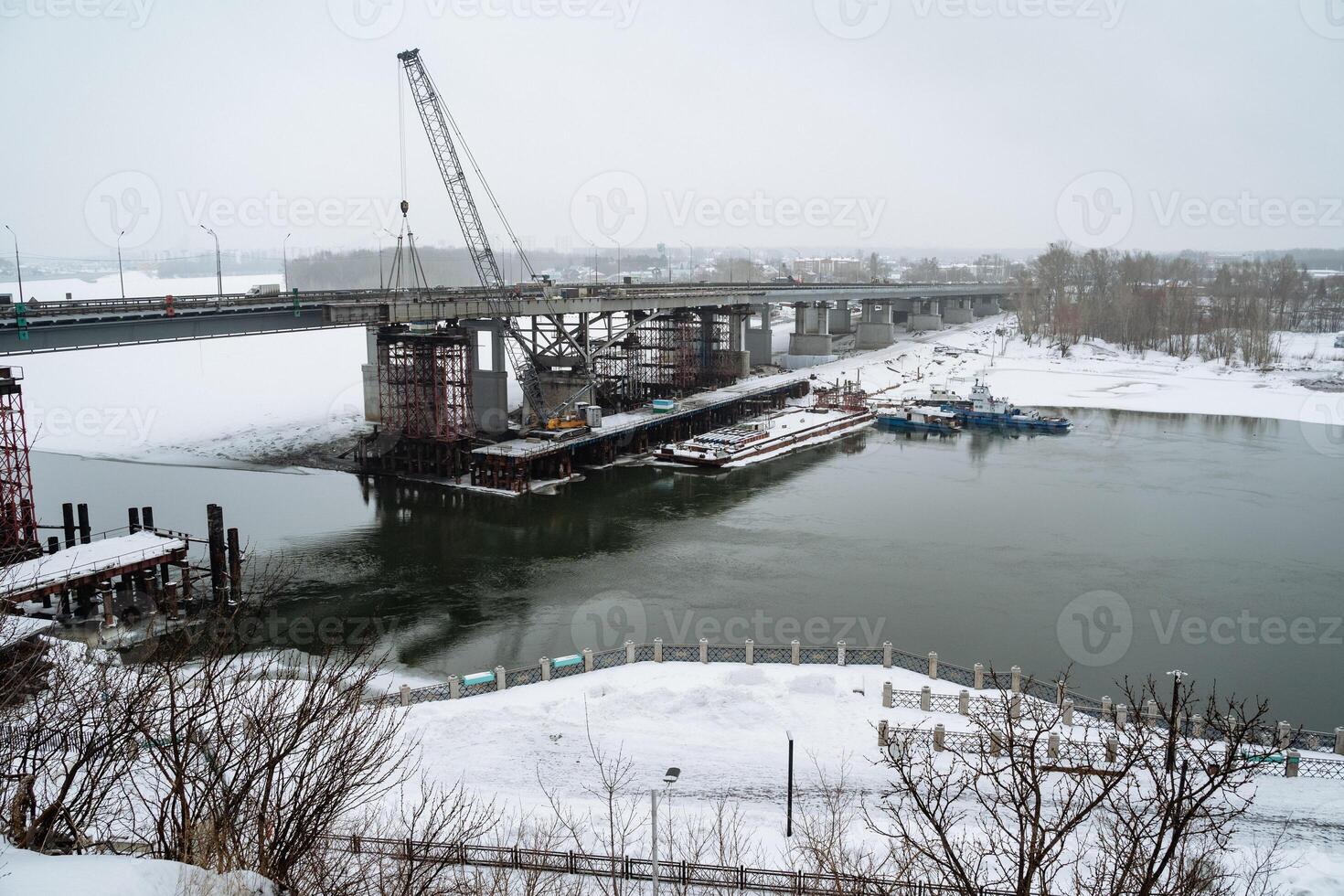 Currently, a bridge is under construction that spans a vast expanse of water, which will facilitate easier transportation and connectivity across this significant geographic feature photo