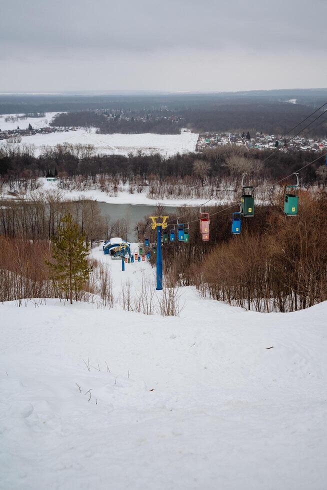 A ski lift is steadily ascending a beautifully snowcovered hill, providing an exhilarating experience for winter sports enthusiasts and offering breathtaking views of the frozen landscape photo