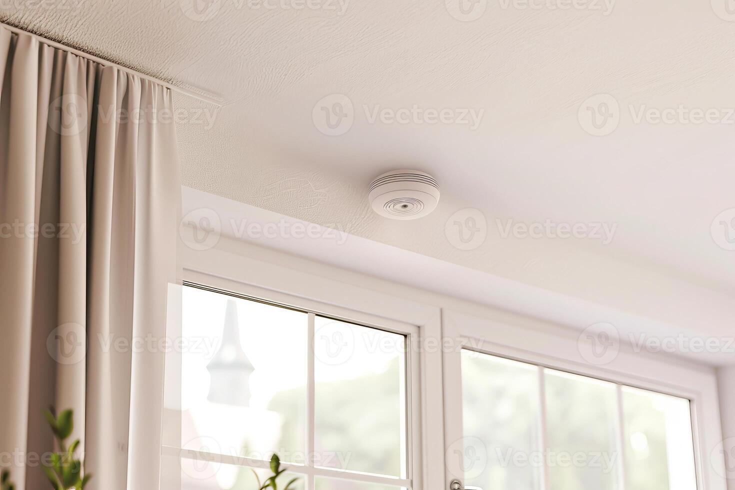 Modern home safety with ceiling smoke detector above large windows and curtains photo