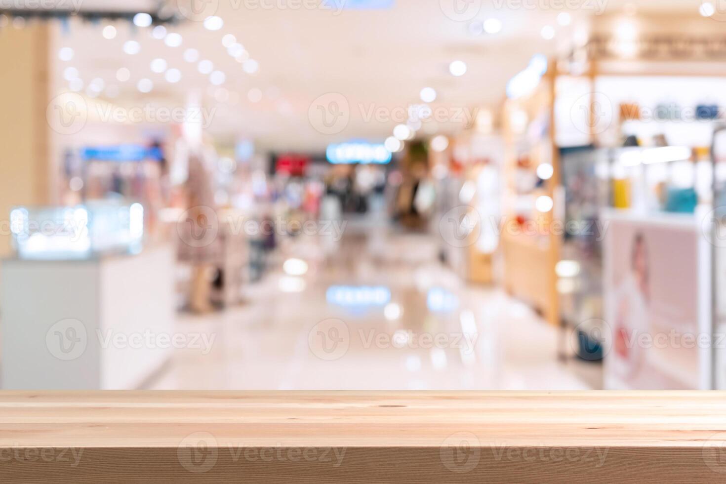 Abstract blurred image of cosmetics department store in the mall with empty table top photo