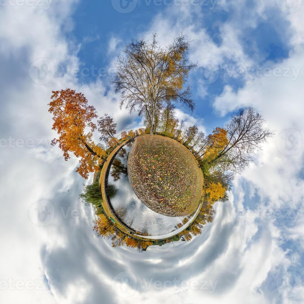 A small planet with trees and water in the sky photo