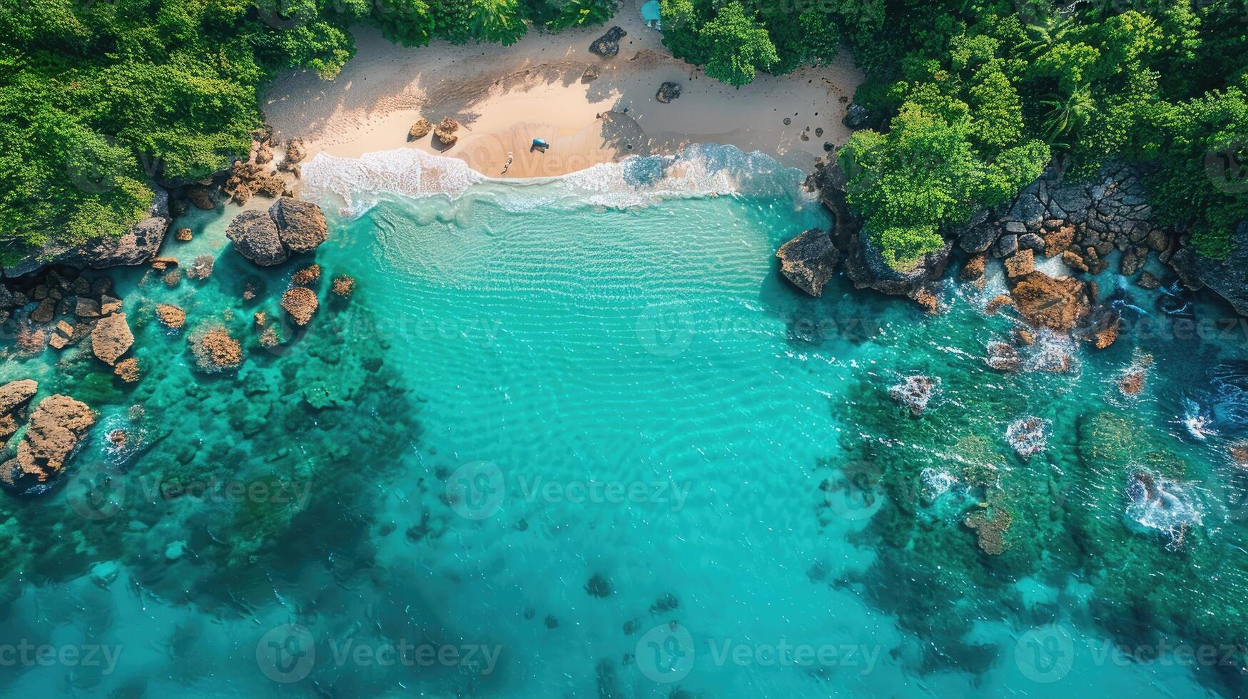 Aerial View of Secluded Tropical Beach with Turquoise Water Lush Greenery and Rocky Coastline photo