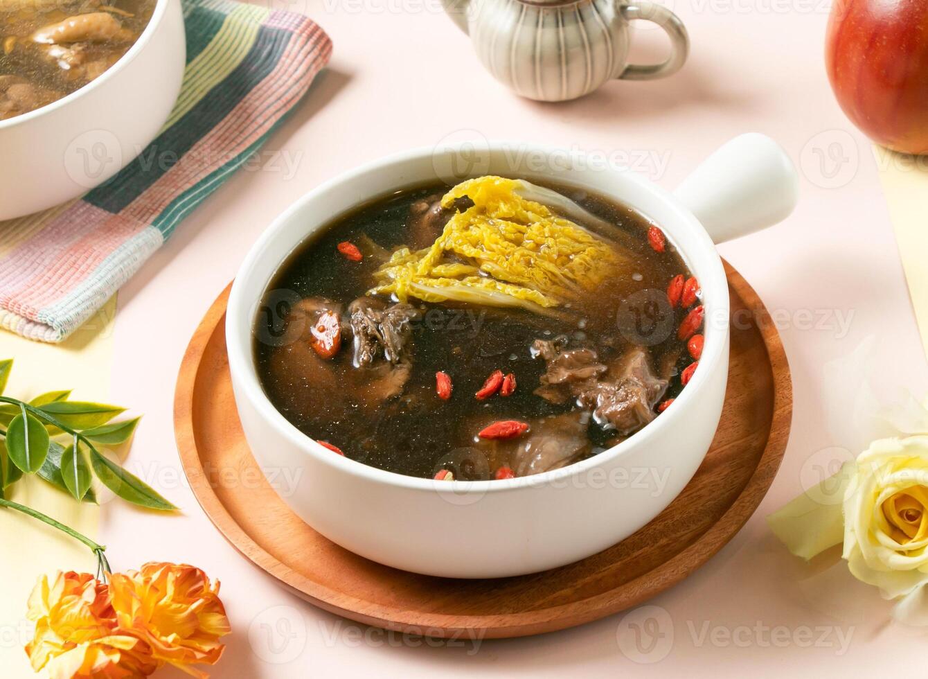 Flavored Chicken Soup taiwan and napa cabbage, garnished with goji berries served in bowl on wooden tray side view of taiwan hot soup photo