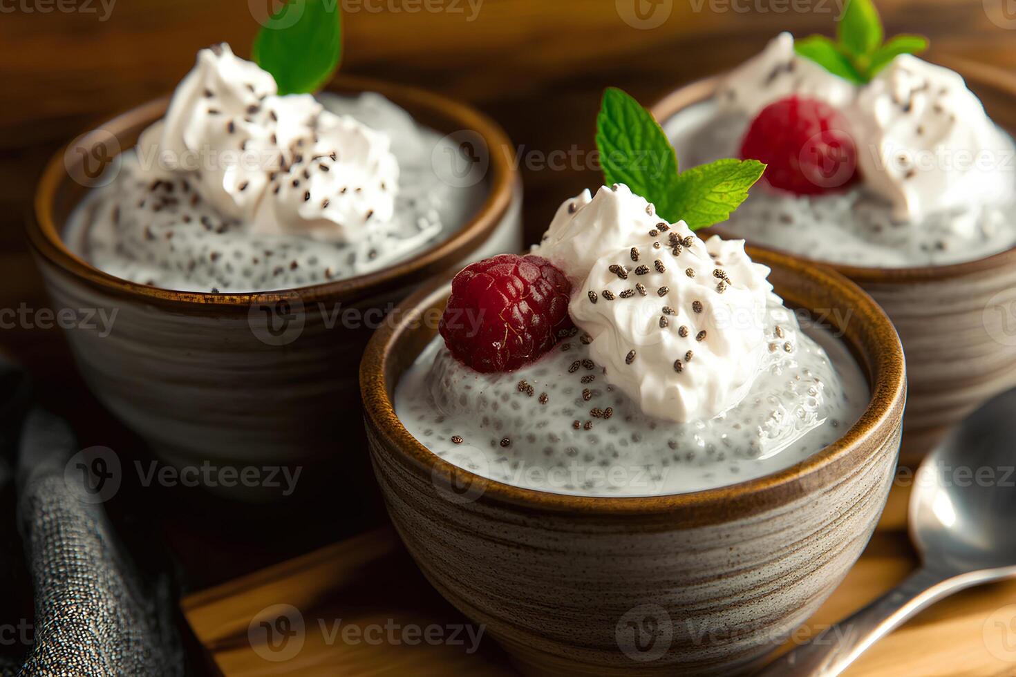Delicious chia seed pudding served in a ceramic bowl, topped with fresh raspberries and whipped cream, creating a healthy and nutritious dessert photo
