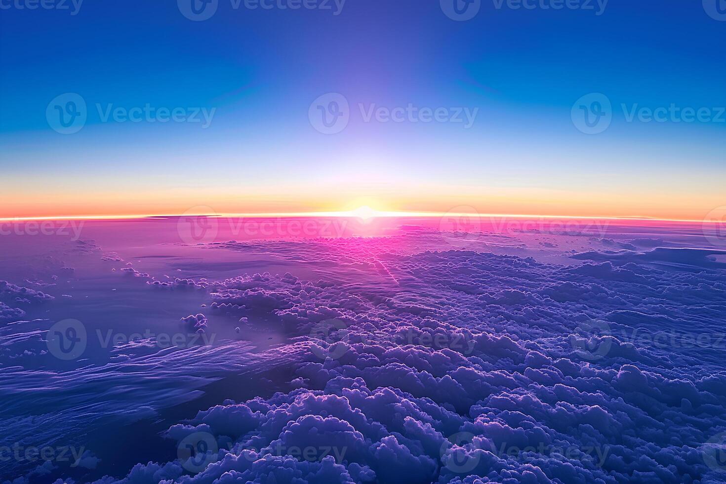 A stunning aerial view of a vibrant sunset above the clouds, captured from an airplane window. The sky is painted with warm hues of orange, pink, and purple, creating a serene photo