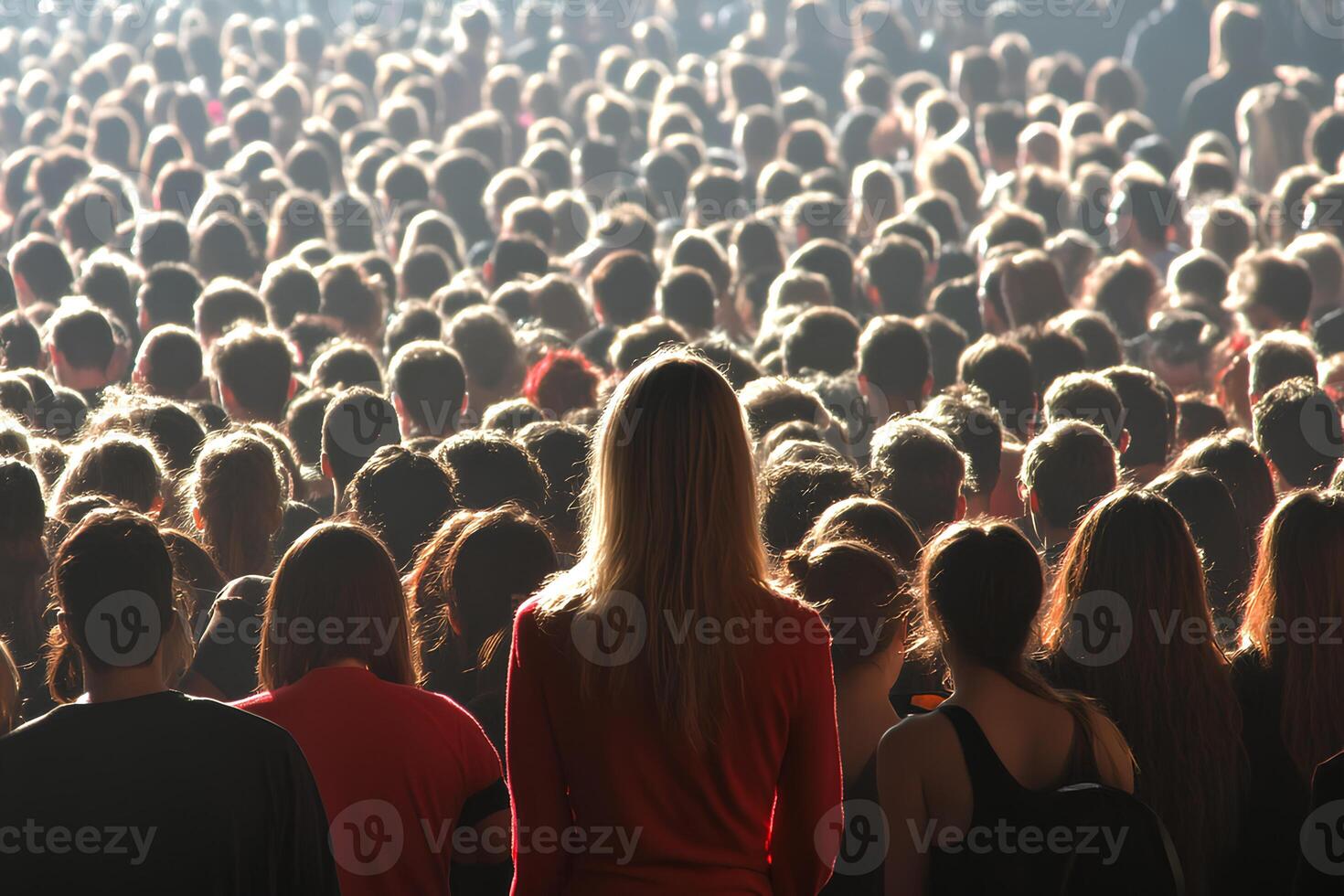 A vibrant crowd enjoying a live concert, with young people raising their hands and dancing. The stage lights illuminate the atmosphere, capturing the excitement and energy of a music festival. photo