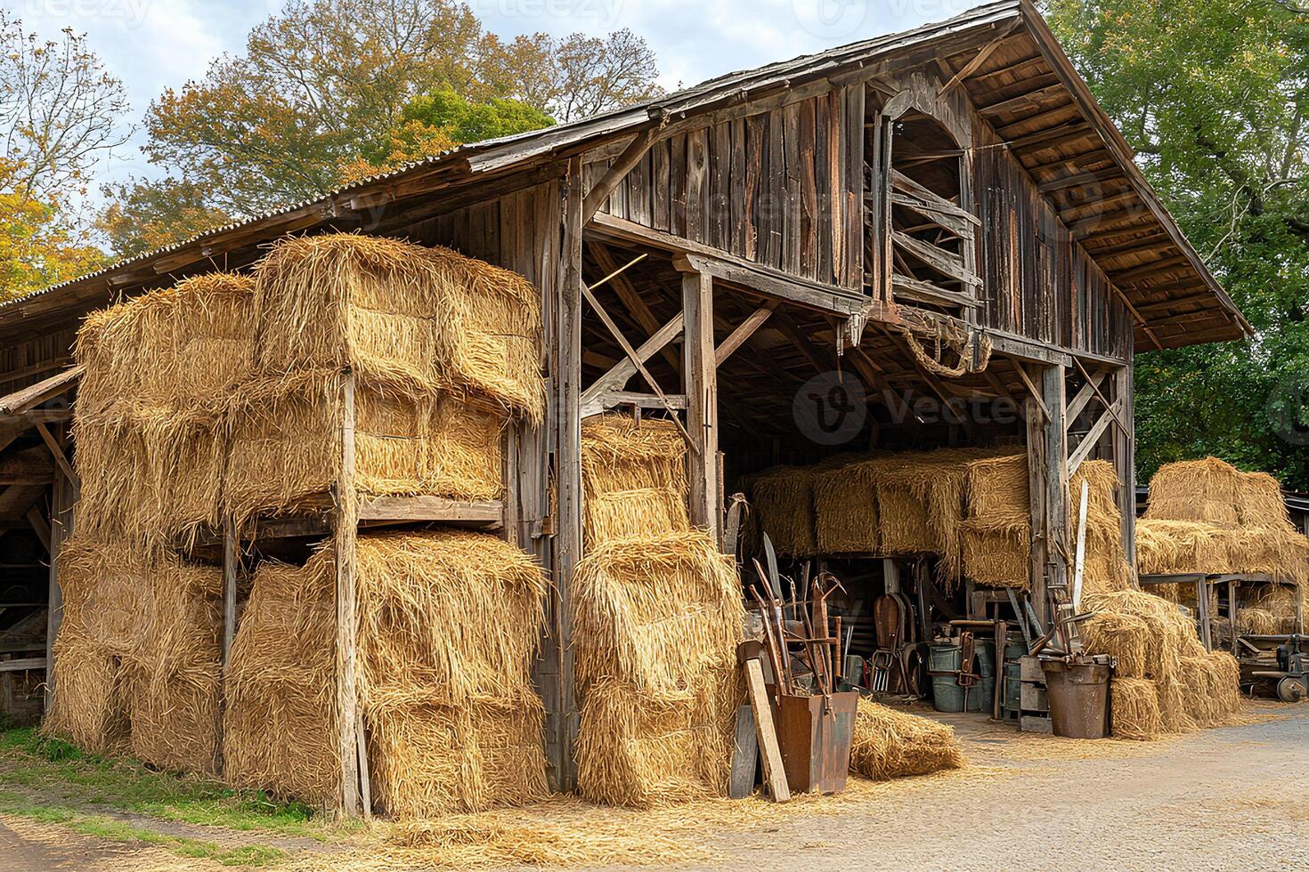 An old, rustic barn surrounded by hay bales in a picturesque rural area of New Jersey. The barn shows signs of wear, adding to its charm photo