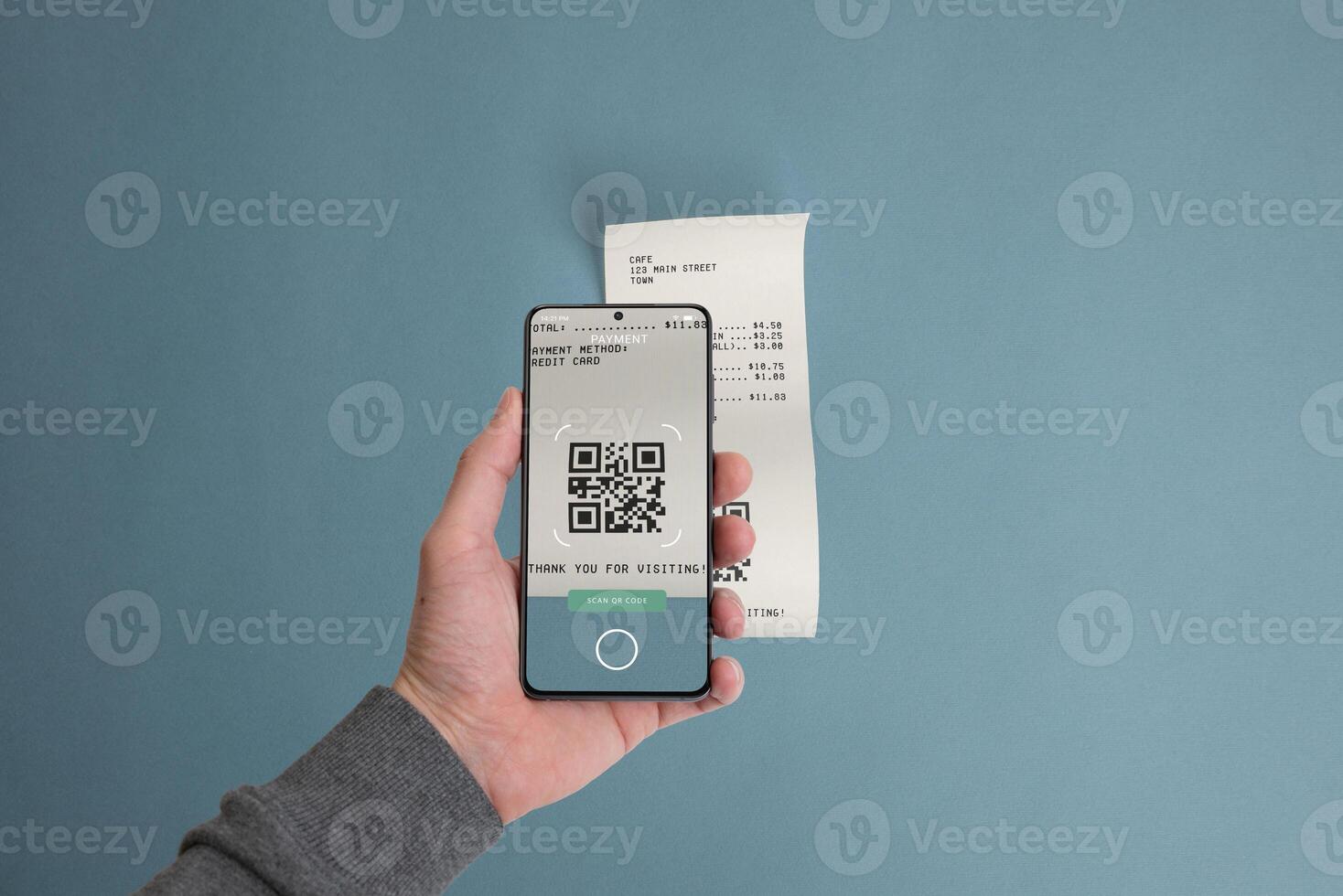 Smartphone scanning a QR code on a paper receipt placed on a table, illustrating the concept of paying bills digitally using mobile technology photo