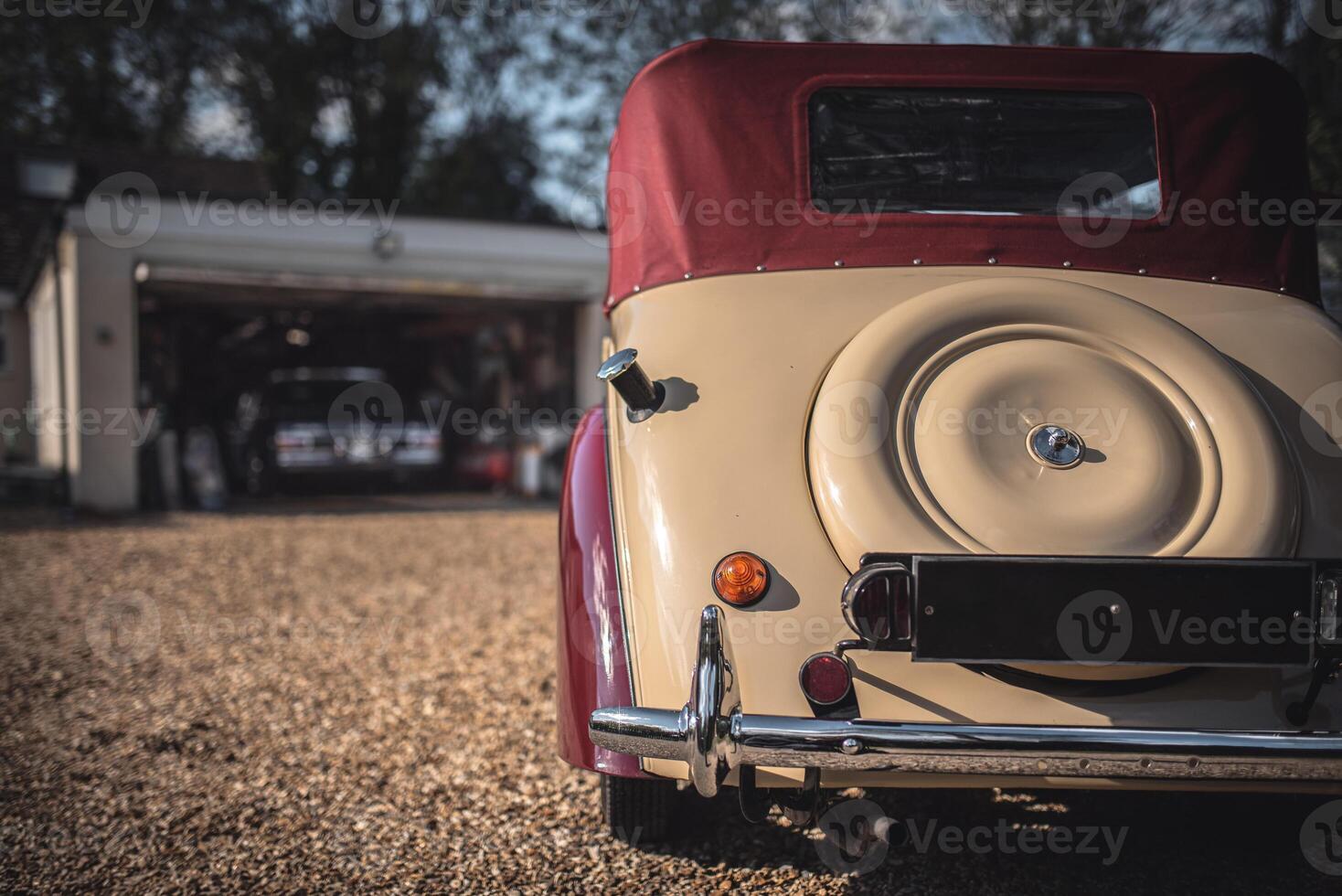 Vintage classic car on a background of a garage where is another German luxury car is positioned. West Sussex, UK photo
