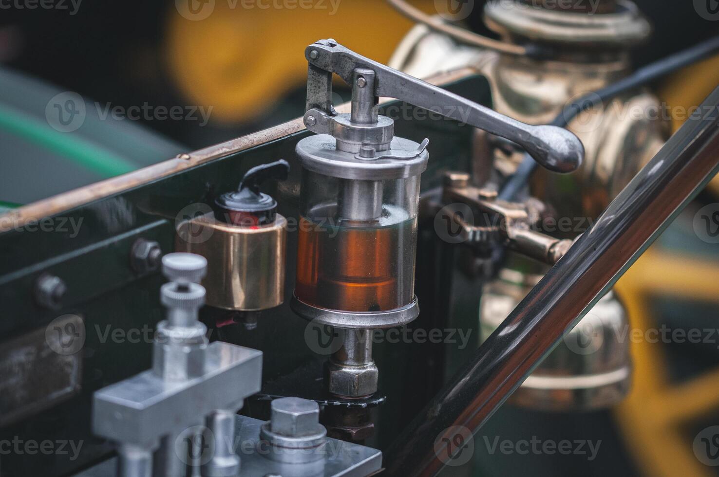 Glass oiler, oil feed, of a vintage, veteran car on a motor show in Brighton, East Sussex, UK photo