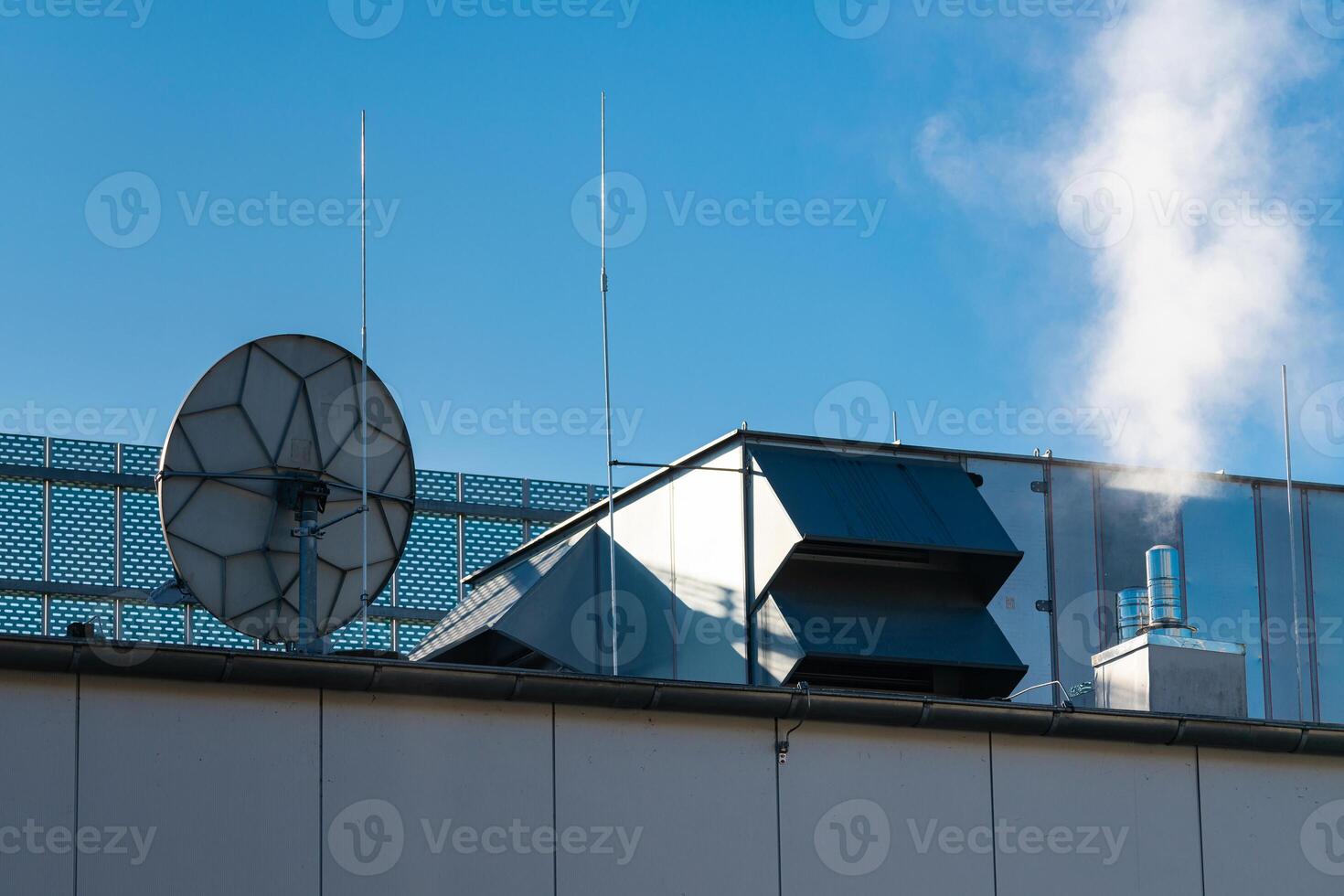 A rooftop equipped with various structures including ventilation ducts photo